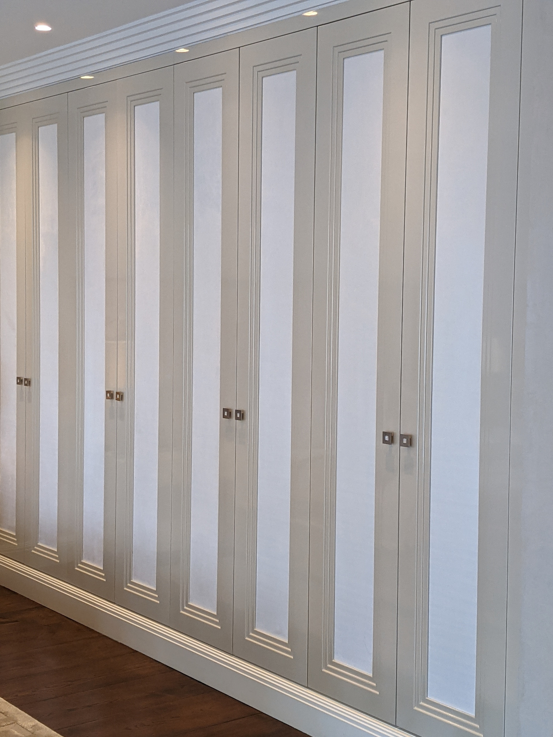 Bespoke Wardrobes, Triple Step design, upholstered in suedette panels