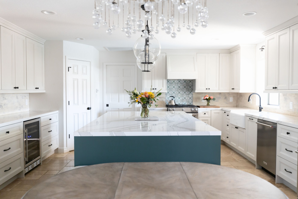 This is an example of a large country u-shaped kitchen in Phoenix with a farmhouse sink, shaker cabinets, green cabinets, quartz benchtops, white splashback, brick splashback, stainless steel appliances, terrazzo floors, with island, beige floor and white benchtop.