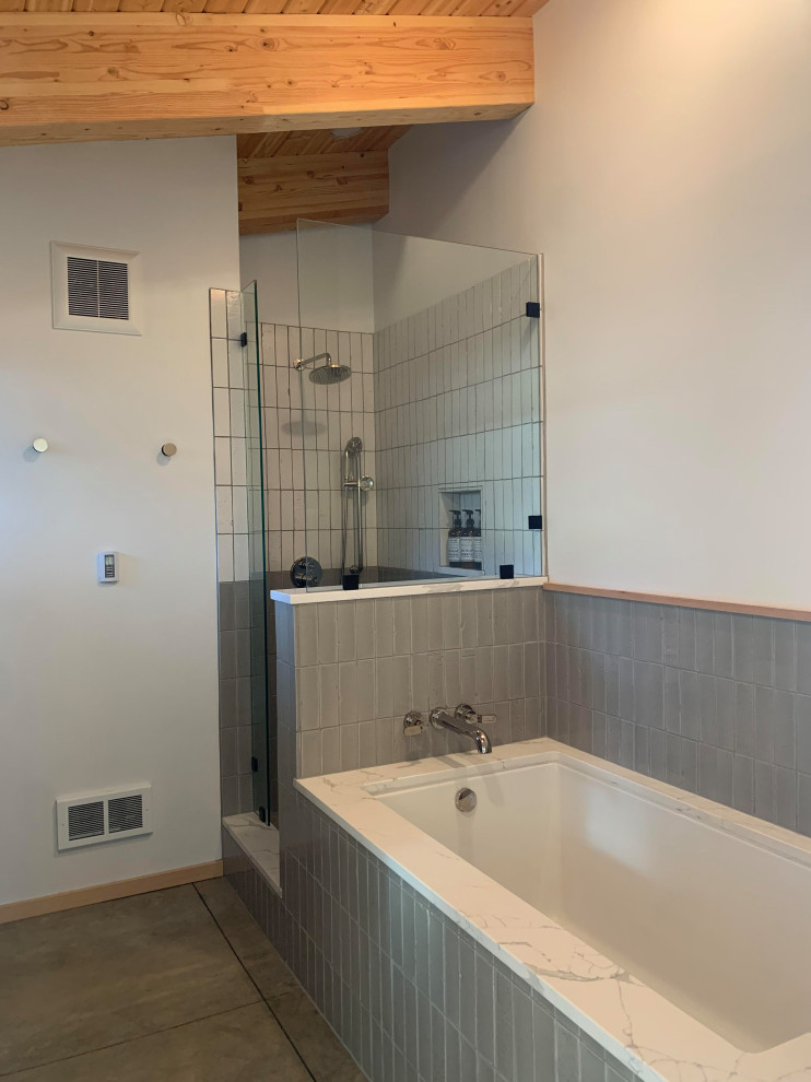 Photo of a medium sized modern ensuite bathroom in Portland with multi-coloured tiles, ceramic tiles, marble worktops, an open shower and brick walls.