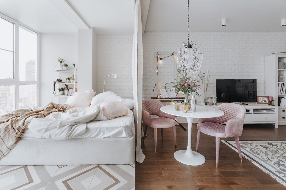 This is an example of a small scandinavian master bedroom in Moscow with white walls, no fireplace and multi-coloured floor.