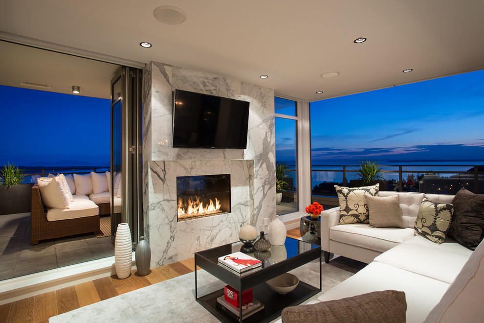 Contemporary living room in Vancouver with a wall-mounted tv.
