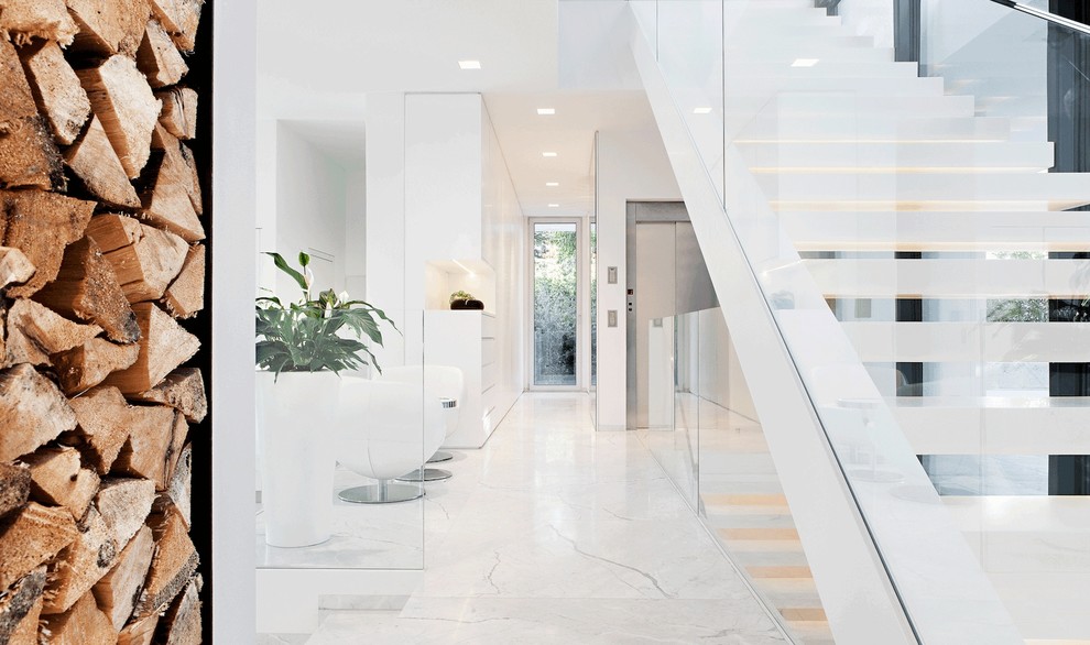 This is an example of a contemporary hallway in Other with white walls and white floor.