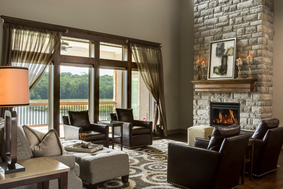 This is an example of a mid-sized transitional open concept family room in Kansas City with grey walls, medium hardwood floors, a standard fireplace, a stone fireplace surround and no tv.