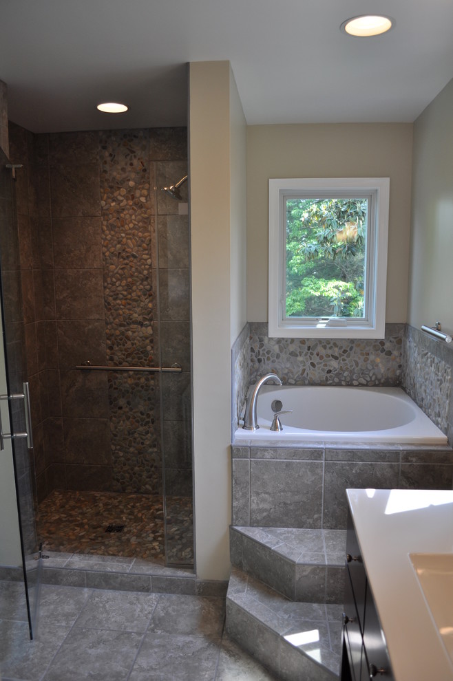 Mid-sized asian master bathroom in DC Metro with flat-panel cabinets, an alcove tub, an alcove shower, beige tile, gray tile, pebble tile, beige walls, ceramic floors and an undermount sink.