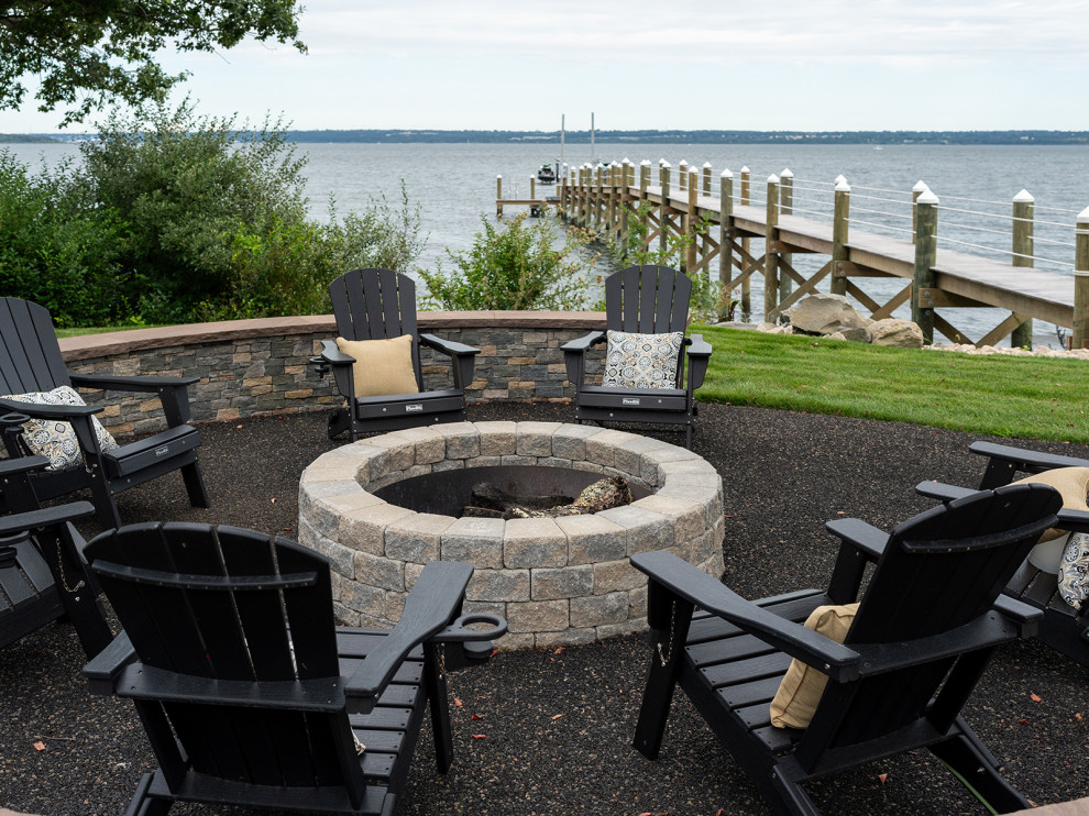 Inspiration for a beach style backyard patio in New York with a fire feature and natural stone pavers.