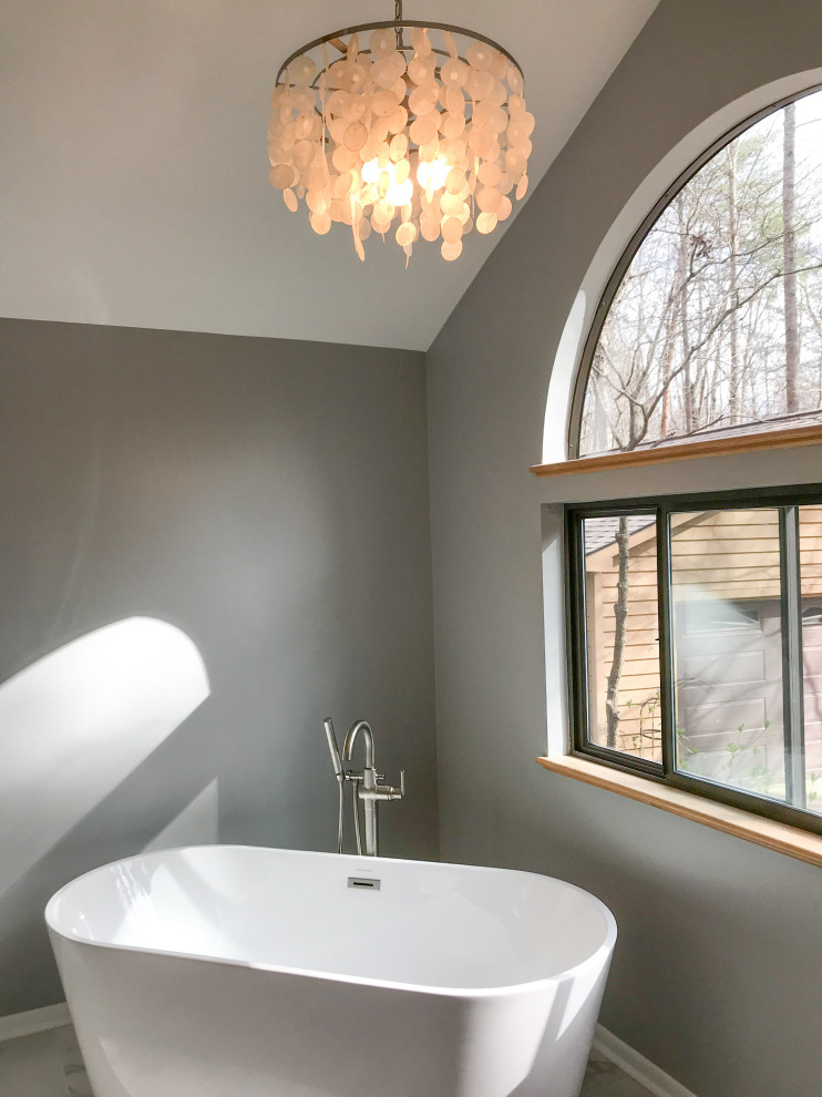 Freestanding bathtub - large modern master black and white tile and porcelain tile porcelain tile and white floor freestanding bathtub idea in Raleigh with flat-panel cabinets, white cabinets, a one-piece toilet, gray walls, an undermount sink, quartz countertops and white countertops