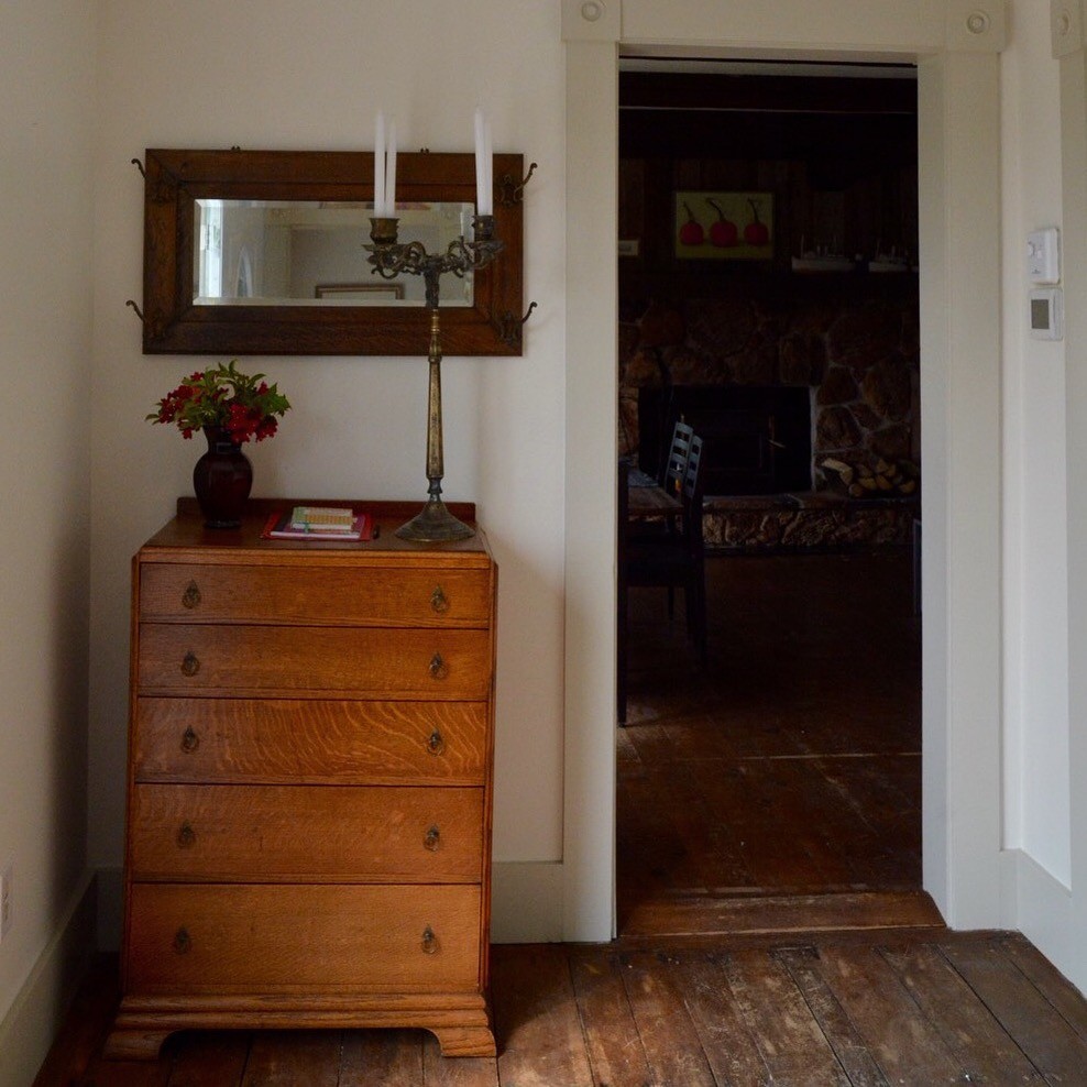 Inspiration for a small rustic dark wood floor hallway remodel with white walls