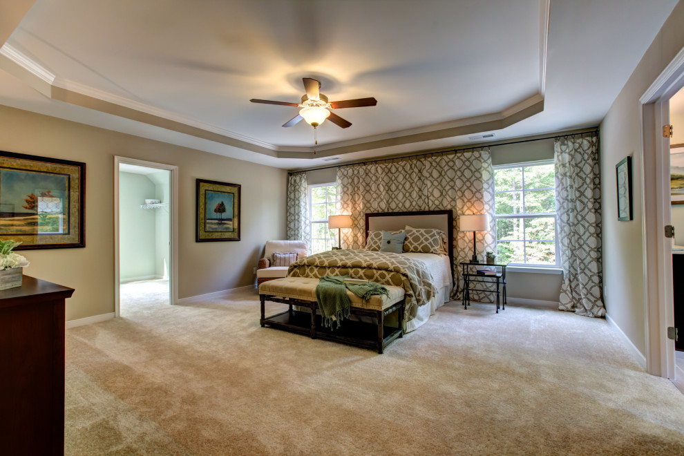 Photo of an expansive traditional master bedroom in Richmond with beige walls, carpet and no fireplace.