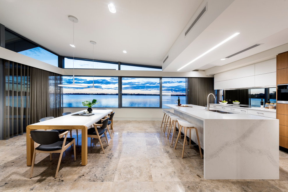 Design ideas for a contemporary galley eat-in kitchen in Perth with a double-bowl sink, flat-panel cabinets, white cabinets, glass tile splashback, with island, brown floor and white benchtop.