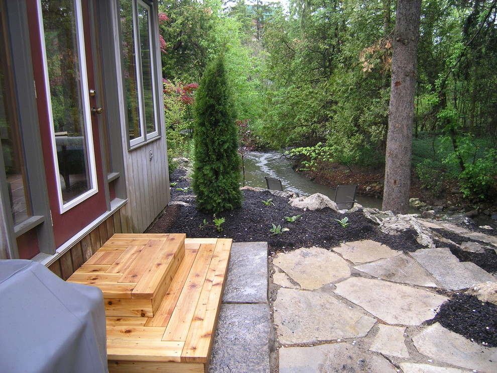 Arts and crafts backyard garden in Toronto with natural stone pavers.
