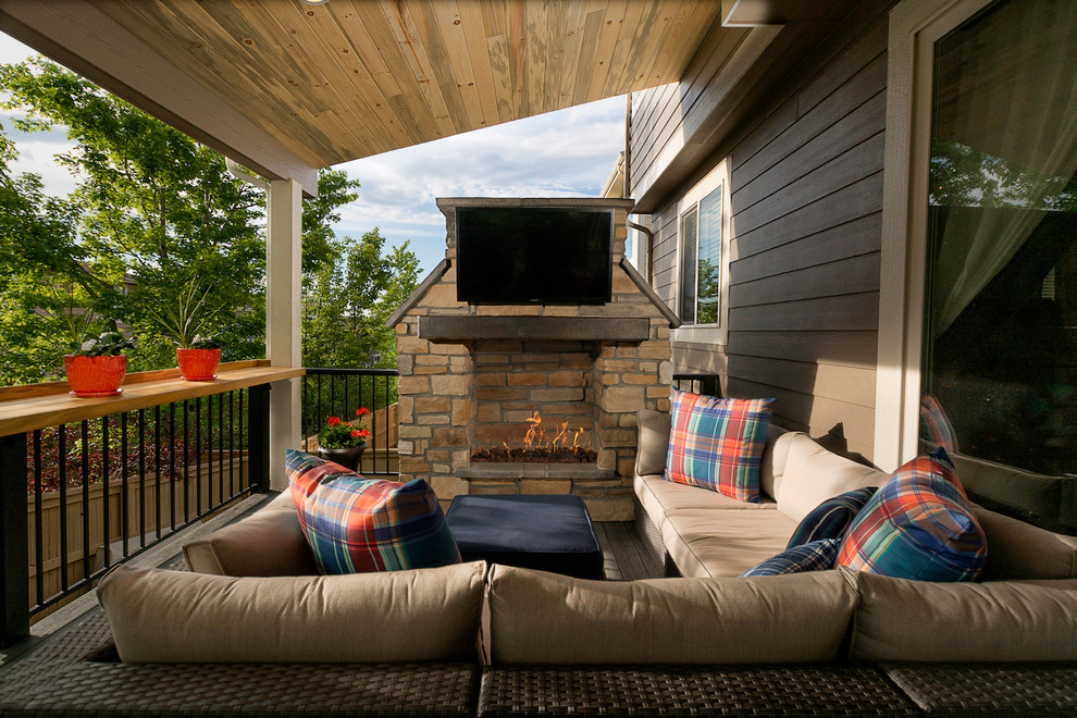 Design ideas for a mid-sized traditional backyard deck in Denver with a fire feature and a roof extension.