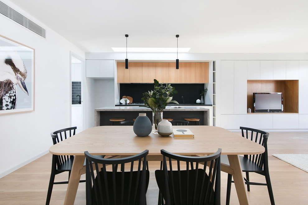 This is an example of a contemporary open plan dining in Melbourne with white walls, dark hardwood floors and beige floor.
