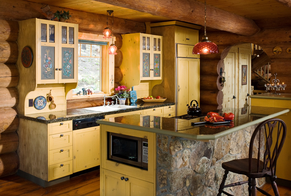 Example of a large mountain style galley medium tone wood floor eat-in kitchen design with a double-bowl sink, shaker cabinets, distressed cabinets, granite countertops, yellow backsplash, wood backsplash, an island and black countertops
