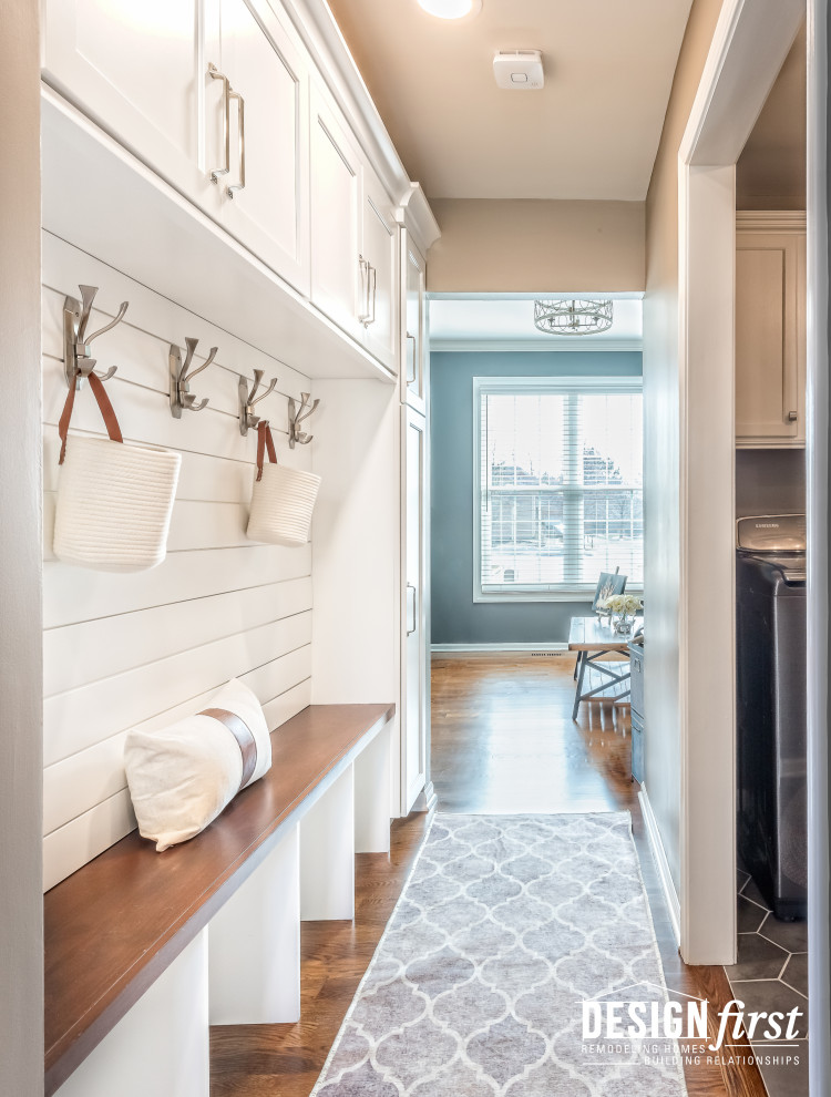 Mid-sized contemporary u-shaped dedicated laundry room in Chicago with shaker cabinets, white cabinets, wood benchtops, beige walls, ceramic floors, a side-by-side washer and dryer, grey floor, brown benchtop and planked wall panelling.