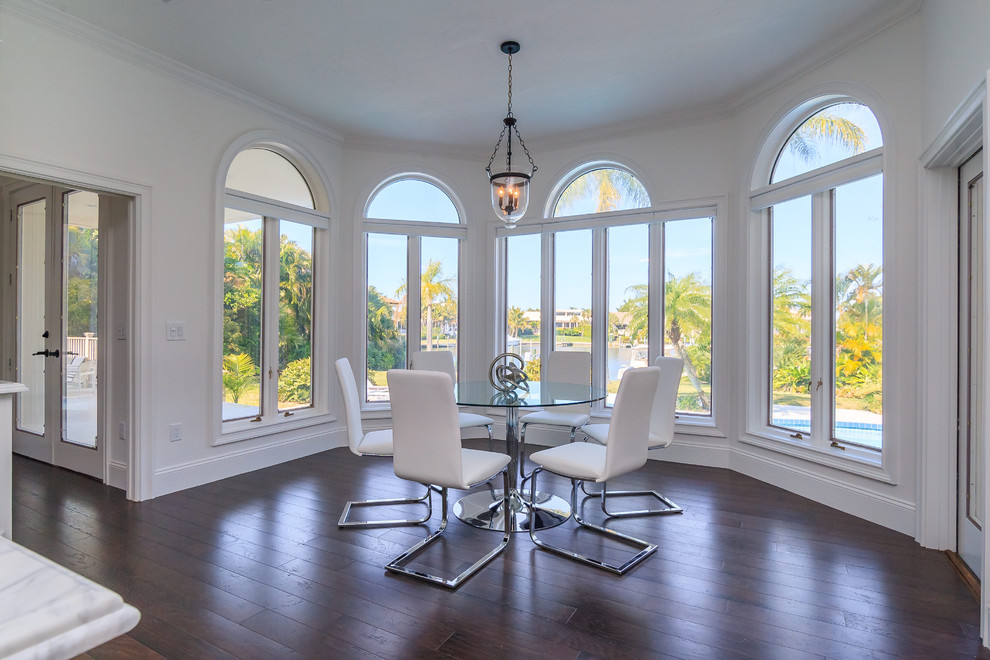 Inspiration for a large contemporary separate dining room in Tampa with white walls and dark hardwood floors.