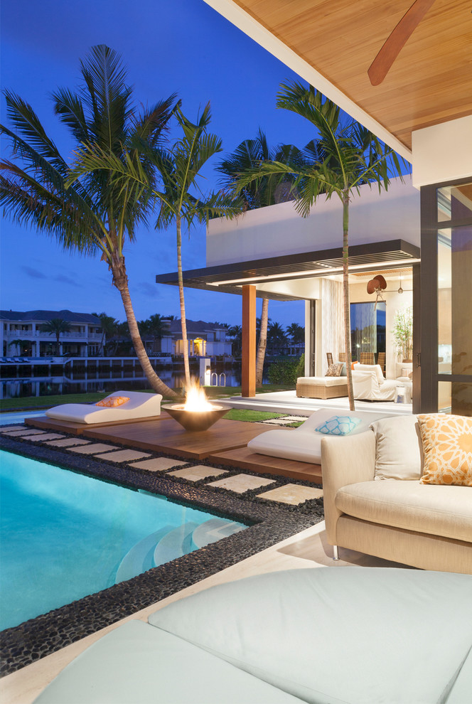 Design ideas for a contemporary patio in Miami with a fire feature.