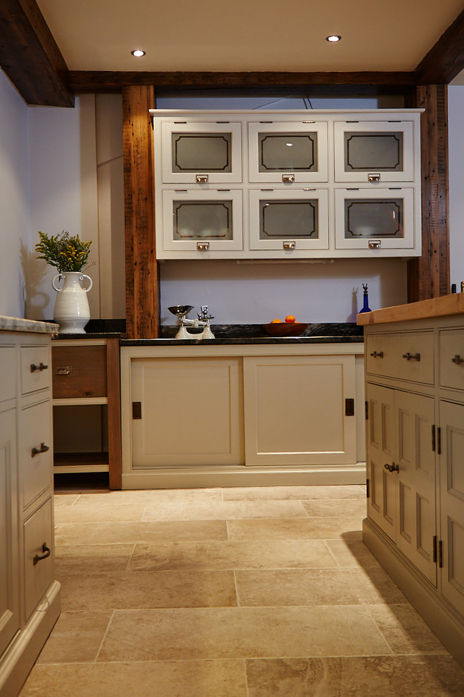 Photo of a large traditional l-shaped eat-in kitchen in Other with an undermount sink, beaded inset cabinets, beige cabinets, wood benchtops, grey splashback, metal splashback, coloured appliances, ceramic floors, with island and beige floor.