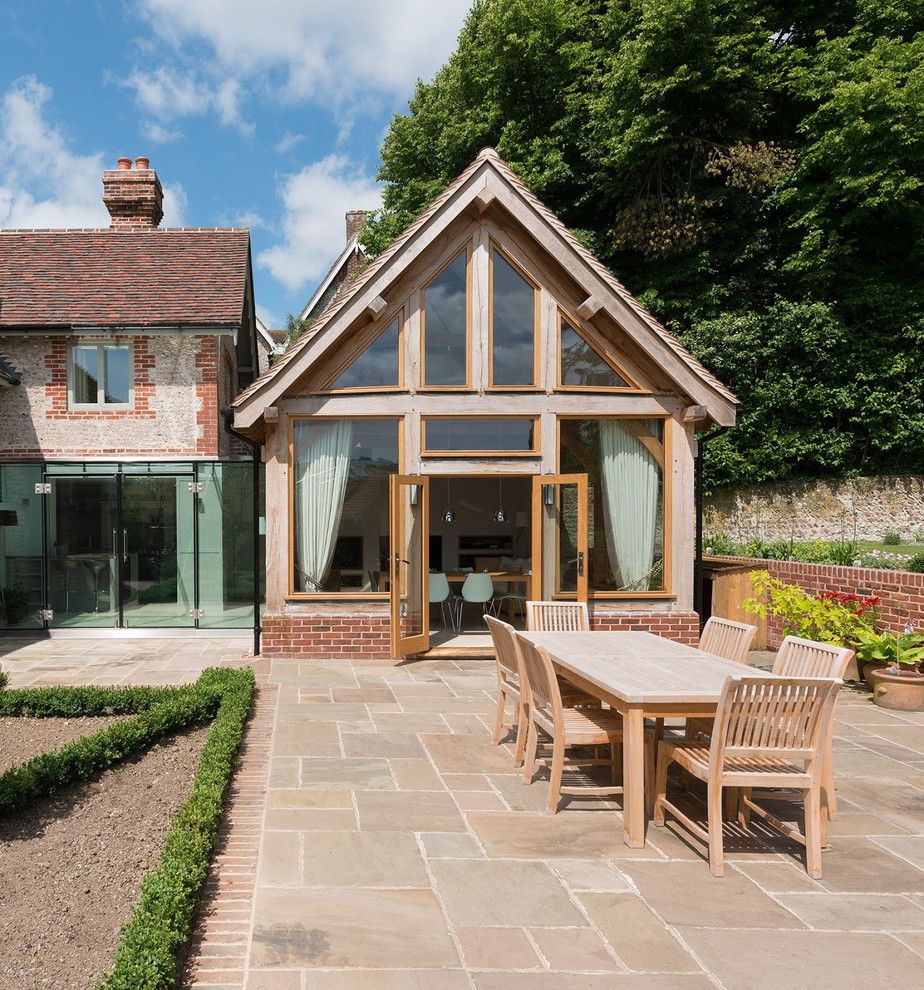 This is an example of a mid-sized traditional patio in Sussex.