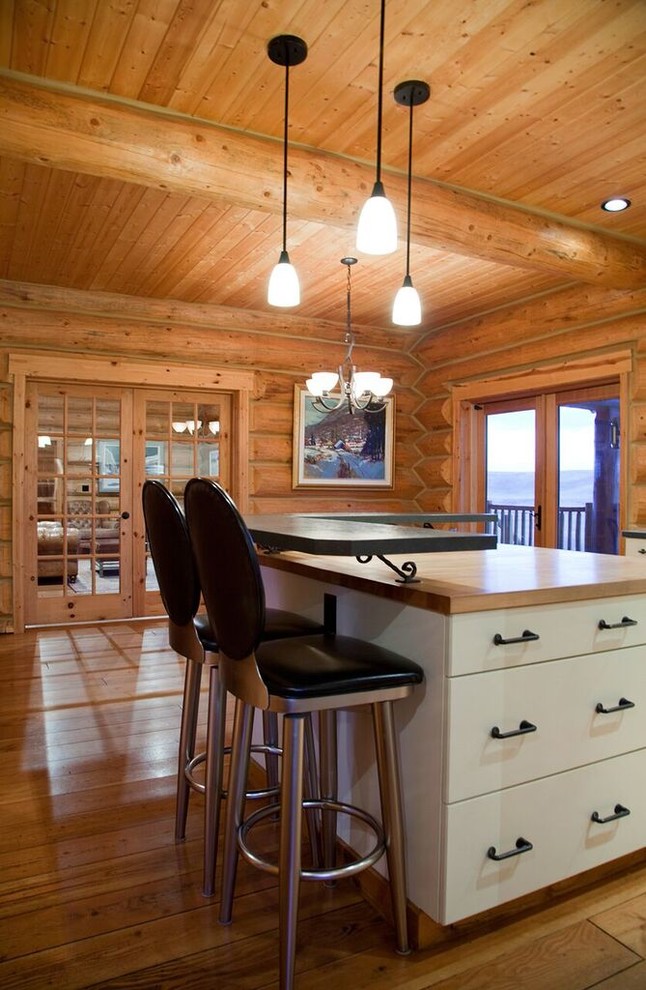 This is an example of a mid-sized country l-shaped kitchen in Other with shaker cabinets, stainless steel appliances, medium hardwood floors and with island.