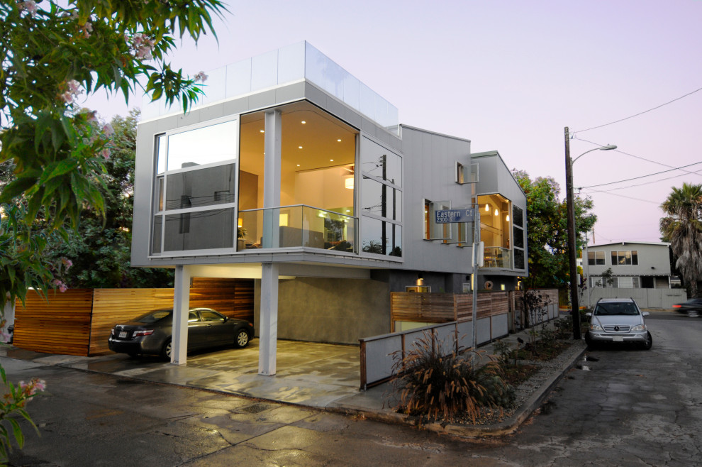 Kleine, Zweistöckige Moderne Doppelhaushälfte mit Glasfassade, weißer Fassadenfarbe, Pultdach, Misch-Dachdeckung und grauem Dach in Los Angeles