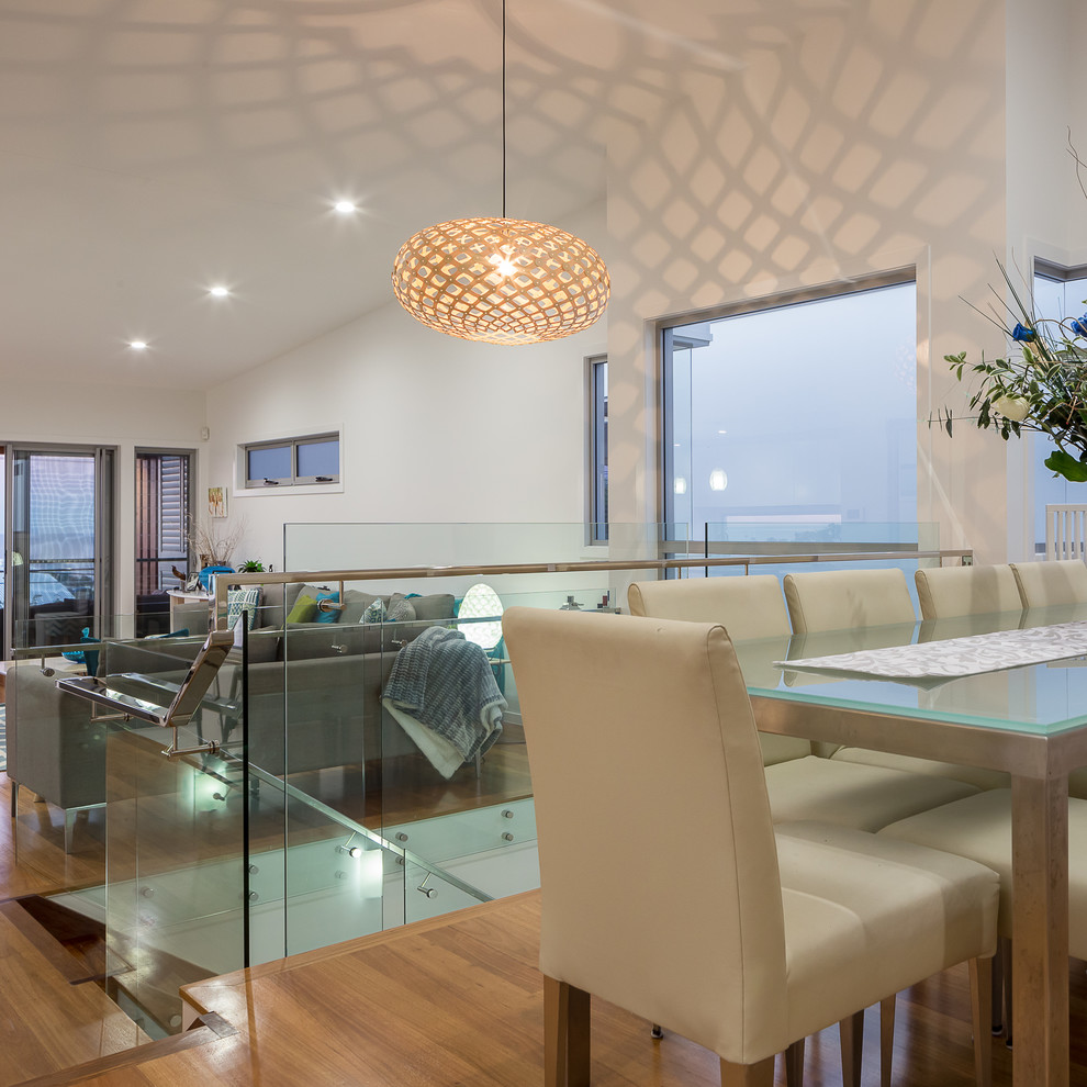 Mid-sized contemporary open plan dining in Brisbane with white walls, light hardwood floors and no fireplace.