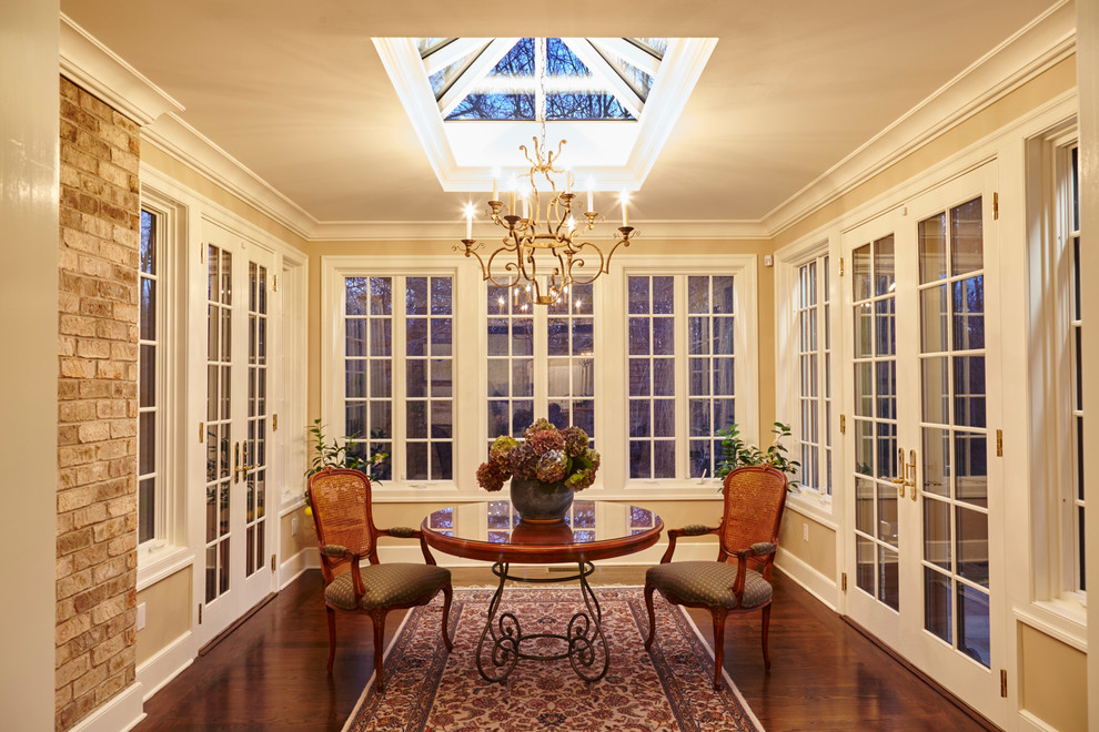 Photo of a mid-sized traditional sunroom in Bridgeport with dark hardwood floors, no fireplace, a skylight and brown floor.