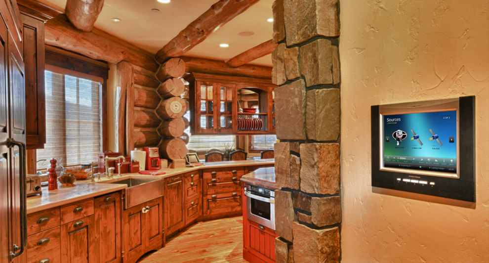 Open concept kitchen - mid-sized rustic single-wall medium tone wood floor open concept kitchen idea in Denver with a drop-in sink, beaded inset cabinets, medium tone wood cabinets, granite countertops, brown backsplash, stainless steel appliances and an island