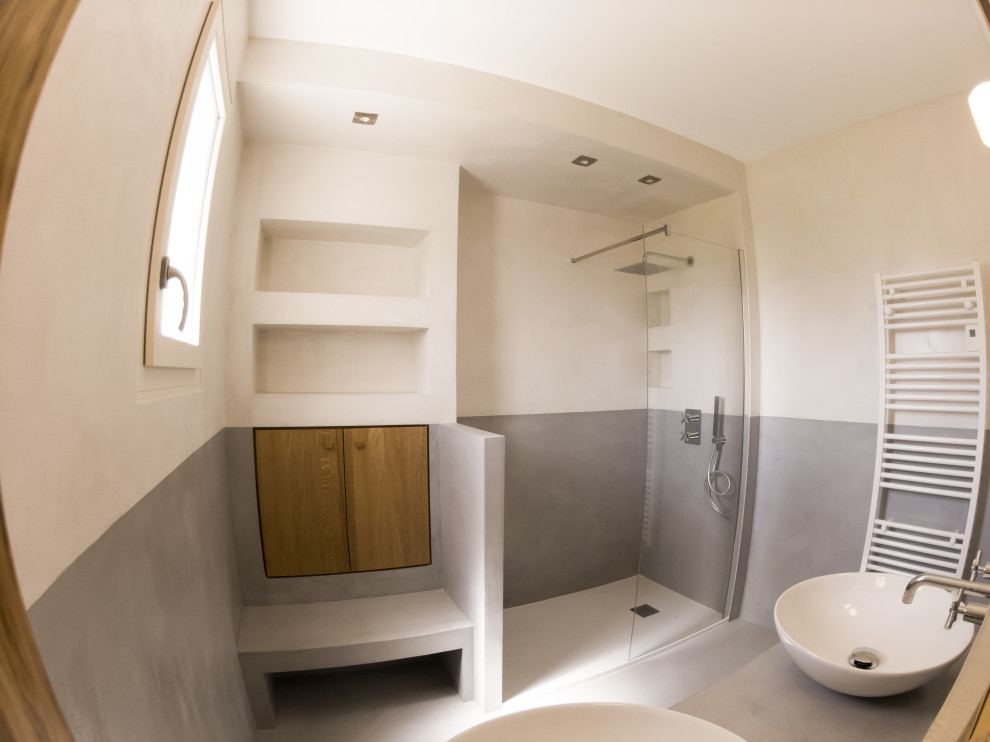 Пример оригинального дизайна: серо-белая ванная комната среднего размера в средиземноморском стиле с фасадами с декоративным кантом, фасадами цвета дерева среднего тона, душем без бортиков, серыми стенами, бетонным полом, душевой кабиной, настольной раковиной, столешницей из бетона, серым полом, серой столешницей, тумбой под две раковины, встроенной тумбой, кессонным потолком, любой отделкой стен и нишей