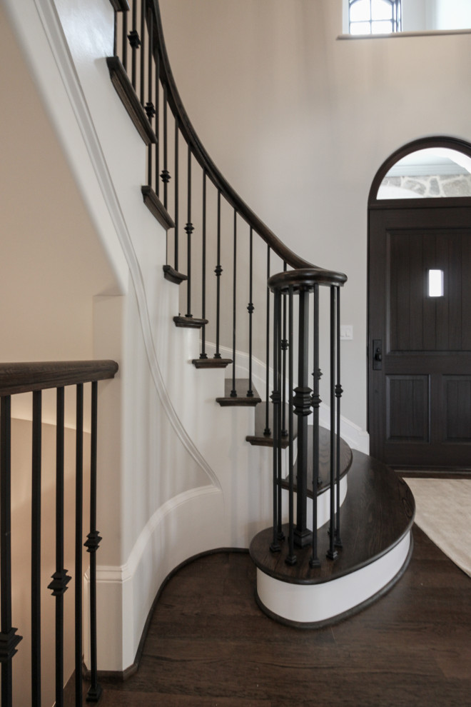 Ejemplo de escalera suspendida clásica grande con escalones de madera, contrahuellas de madera pintada y barandilla de metal