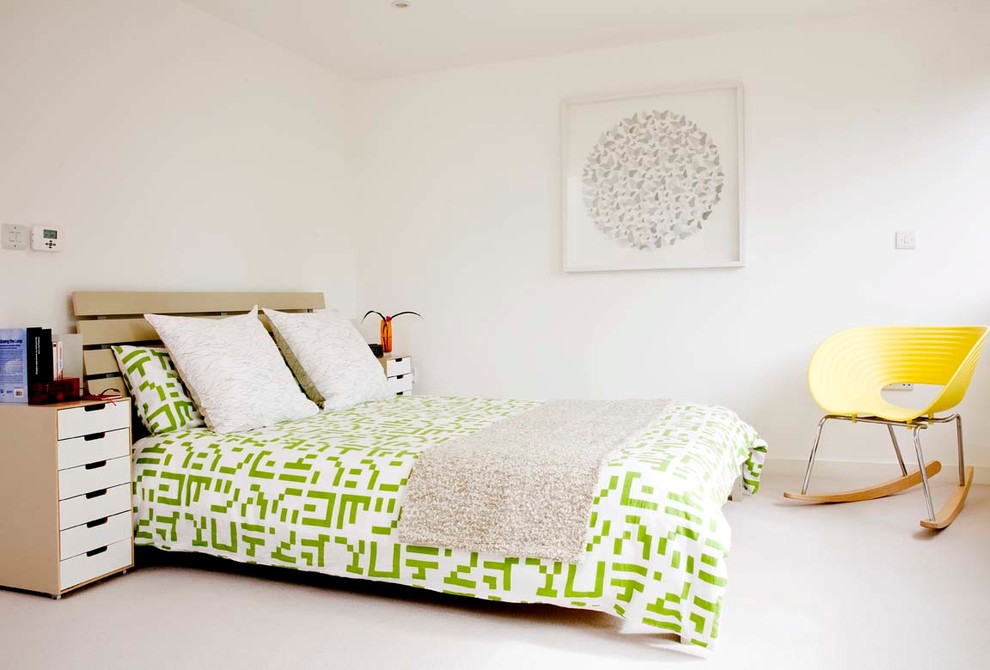 Inspiration for a mid-sized contemporary master bedroom in Surrey with white walls and carpet.