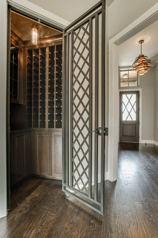Design ideas for a small transitional wine cellar in Dallas with medium hardwood floors and storage racks.