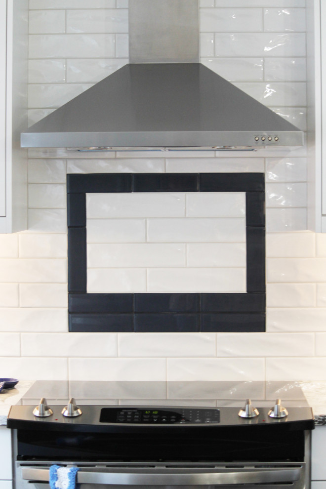 Inspiration for a large transitional u-shaped eat-in kitchen remodel with shaker cabinets, white cabinets, quartz countertops, white backsplash, subway tile backsplash, stainless steel appliances, an island and gray countertops