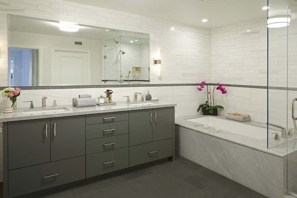 Mid-sized contemporary master bathroom in Los Angeles with an undermount sink, flat-panel cabinets, grey cabinets, an undermount tub, a corner shower, white tile, marble benchtops, stone tile, white walls and grey floor.