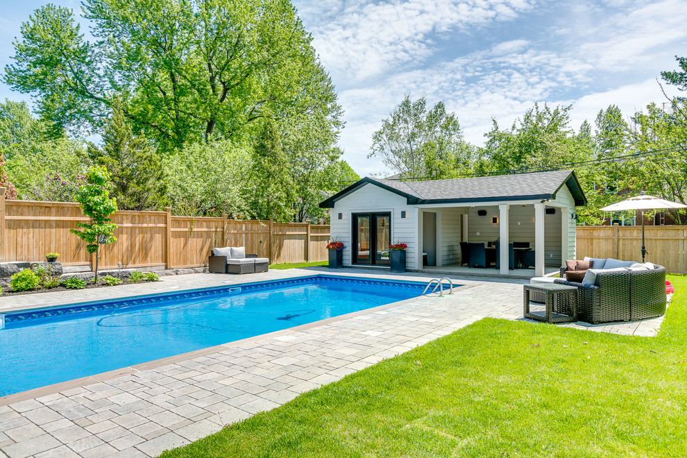 Large transitional backyard stone and rectangular lap pool house photo in Toronto