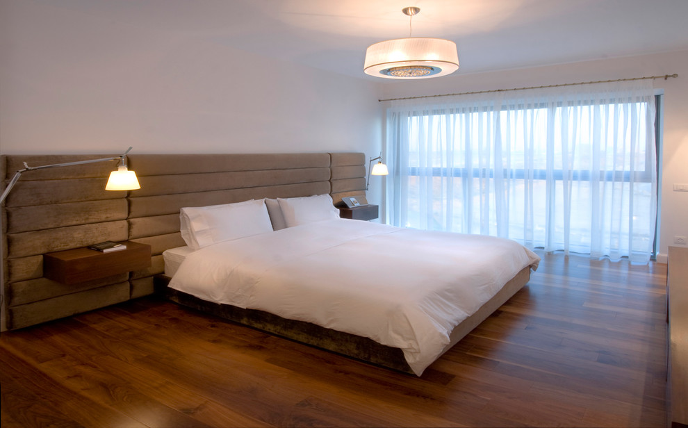 Contemporary bedroom in Other with medium hardwood floors.