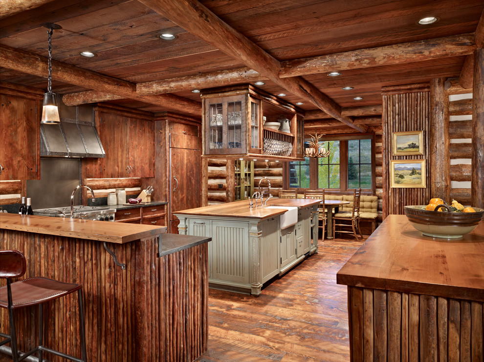 Photo of an expansive country kitchen in Other with a farmhouse sink, flat-panel cabinets, dark wood cabinets, wood benchtops, brown splashback, panelled appliances, dark hardwood floors, multiple islands, timber splashback and brown floor.