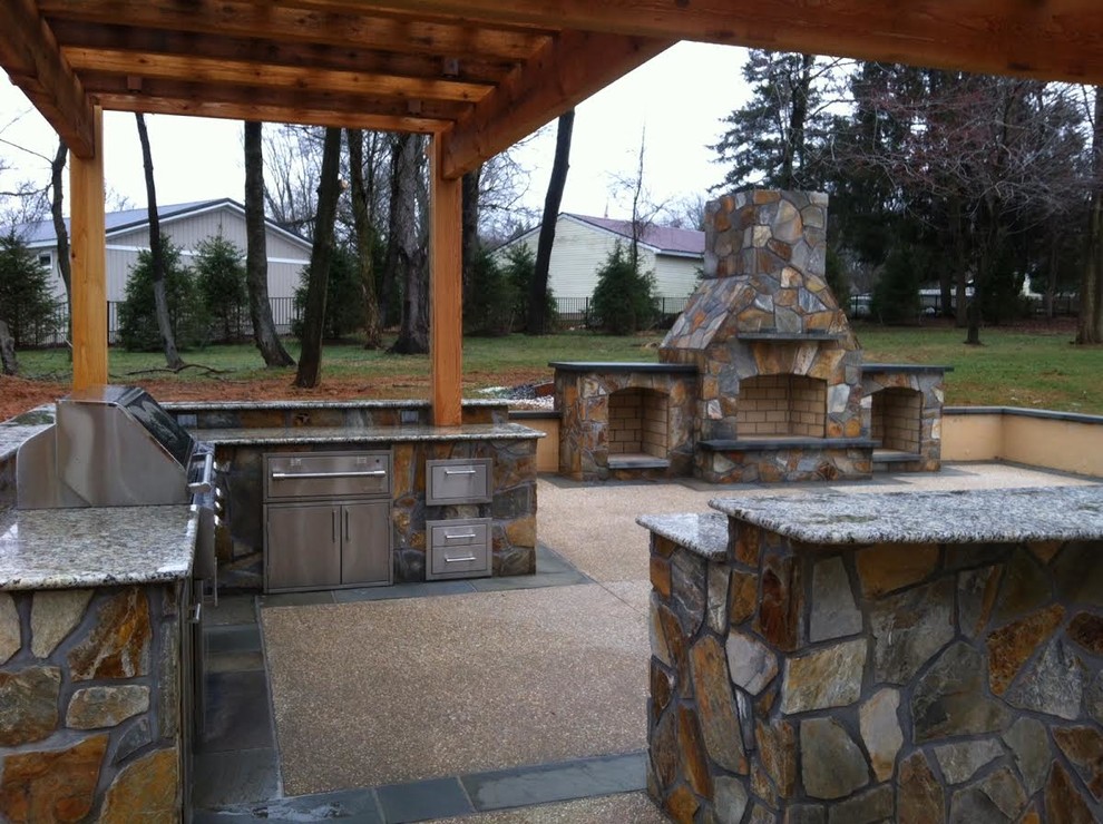Inspiration for a mid-sized transitional backyard concrete paver patio remodel in Baltimore with a pergola