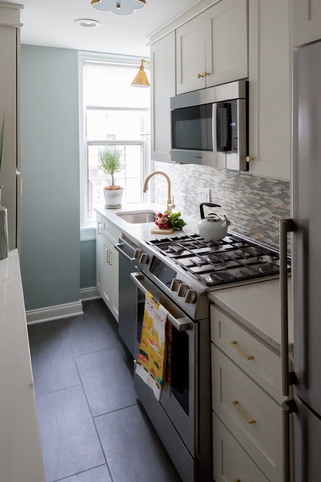 Kitchen - small transitional galley kitchen idea in DC Metro with shaker cabinets, white cabinets, glass tile backsplash and stainless steel appliances