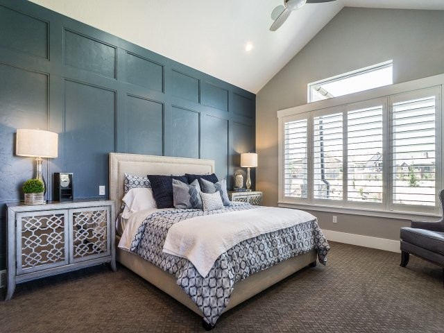 This is an example of a mid-sized transitional master bedroom in Salt Lake City with grey walls, carpet and a standard fireplace.
