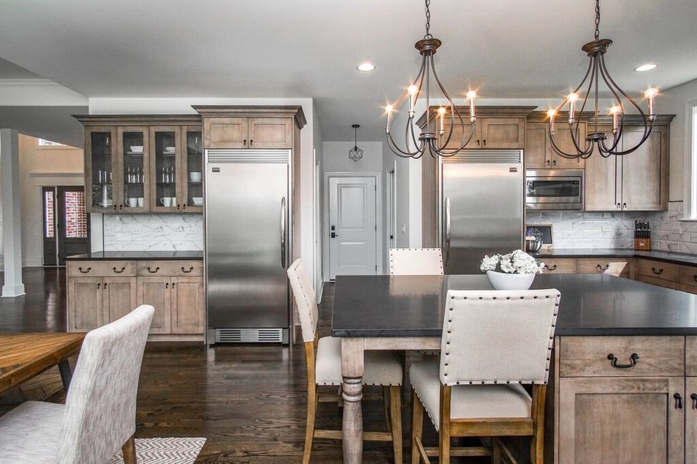 Eat-in kitchen - transitional u-shaped dark wood floor and black floor eat-in kitchen idea in Chicago with an undermount sink, shaker cabinets, granite countertops, white backsplash, ceramic backsplash, stainless steel appliances, an island and black countertops