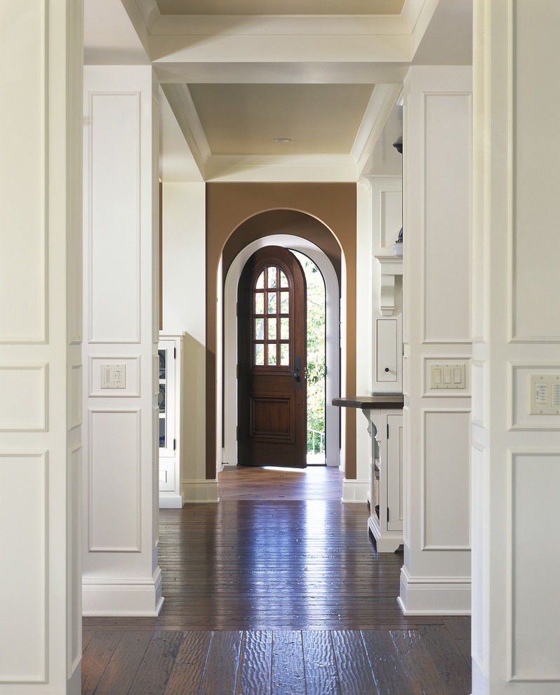 Design ideas for a large traditional hallway in Grand Rapids with white walls and dark hardwood floors.