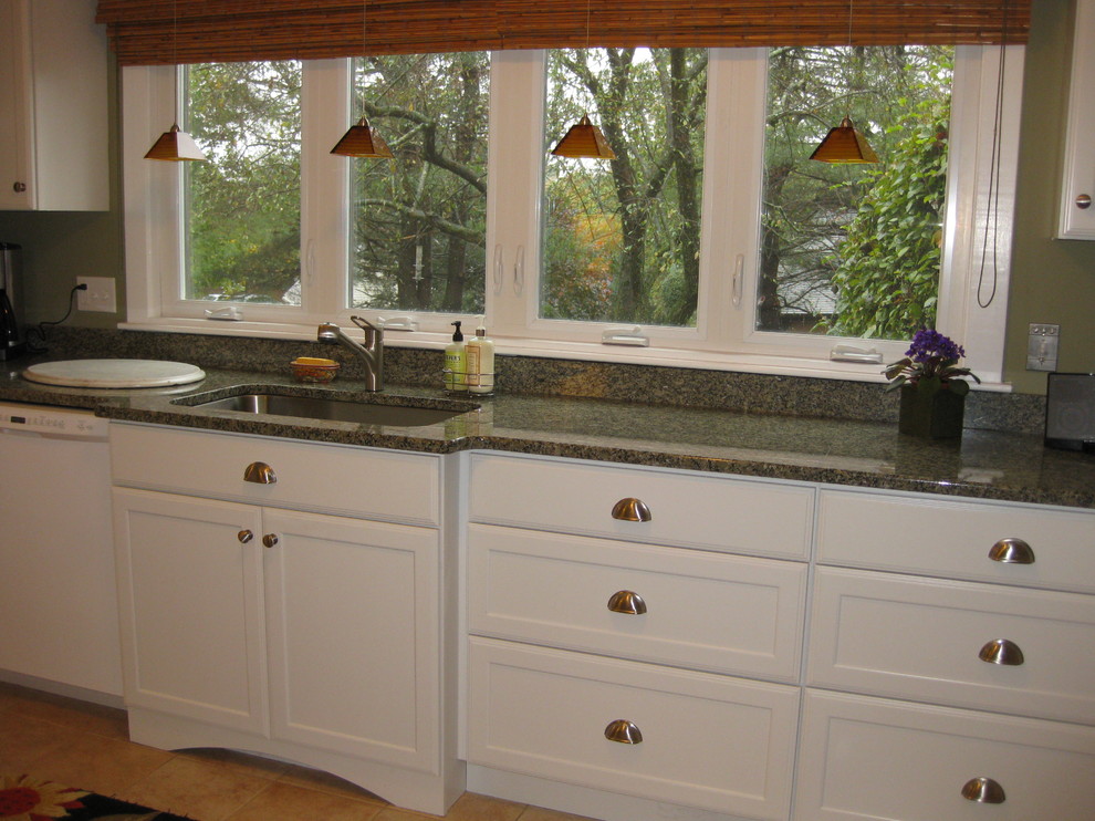 Kitchen - transitional l-shaped ceramic tile and beige floor kitchen idea in Boston with an undermount sink, shaker cabinets, white cabinets, granite countertops, white appliances and green countertops