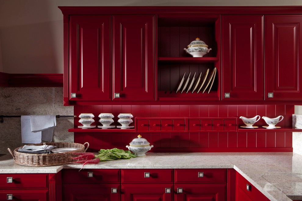 Large contemporary l-shaped eat-in kitchen in New York with a farmhouse sink, raised-panel cabinets, red cabinets, granite benchtops, stainless steel appliances and no island.