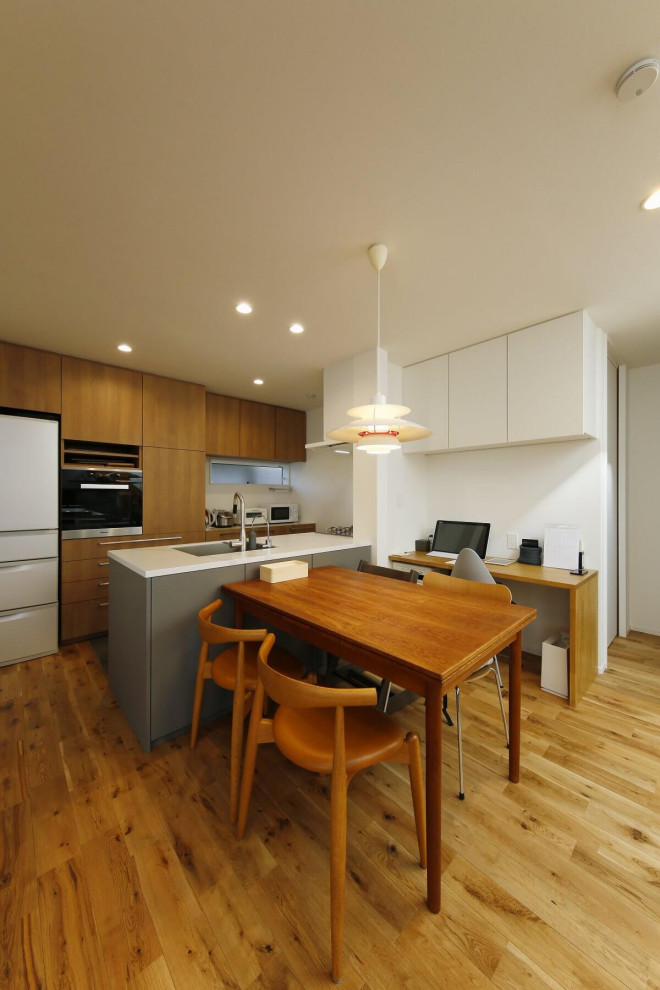 Example of a mid-sized urban medium tone wood floor, brown floor, wallpaper ceiling and wallpaper great room design in Tokyo Suburbs with white walls