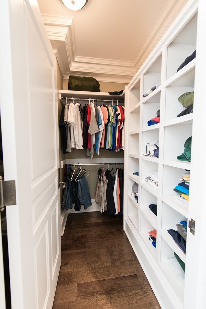 Mid-sized traditional gender-neutral walk-in wardrobe in New York with open cabinets, white cabinets and dark hardwood floors.