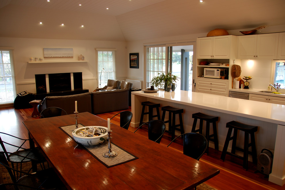 Inspiration for a large country l-shaped kitchen in Geelong with an undermount sink, recessed-panel cabinets, beige cabinets, quartz benchtops, beige splashback, glass sheet splashback, stainless steel appliances, medium hardwood floors and with island.