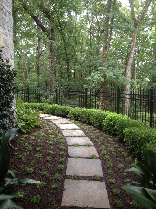Inspiration for a mid-sized country side yard partial sun formal garden in Atlanta with a garden path and mulch.