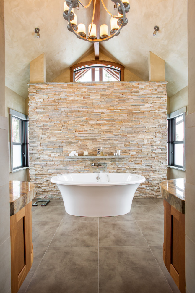 Photo of a large country master bathroom in Denver with medium wood cabinets, a double shower, beige tile, ceramic floors, granite benchtops, a hinged shower door, beige benchtops and a double vanity.