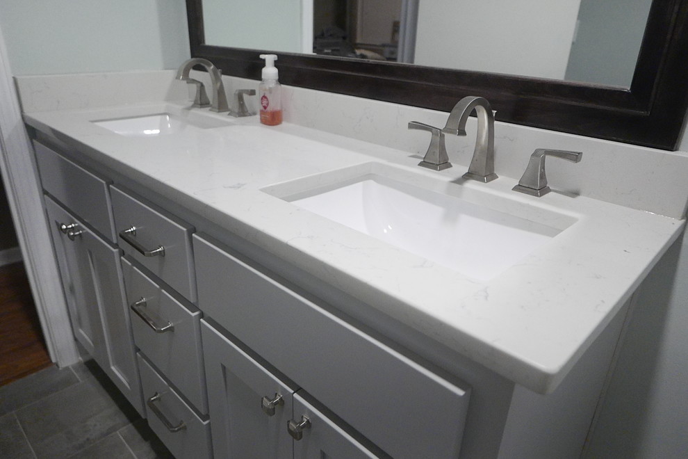 Alcove bathtub - mid-sized transitional kids' white tile and porcelain tile porcelain tile and gray floor alcove bathtub idea with shaker cabinets, gray cabinets, a two-piece toilet, green walls, an undermount sink, quartz countertops and white countertops