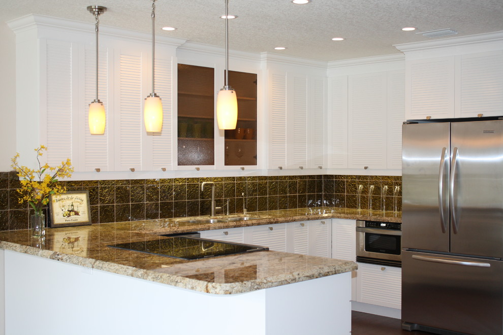 Inspiration for a large transitional u-shaped dark wood floor eat-in kitchen remodel in Miami with an undermount sink, louvered cabinets, white cabinets, granite countertops, black backsplash, stone tile backsplash, stainless steel appliances and an island